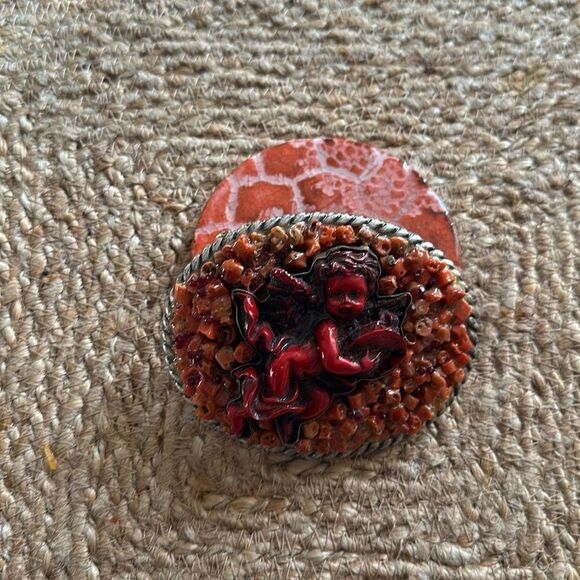 Handmade Coral Cherub belt buckle. One-of-a-kind.